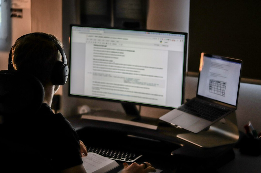 programmer at desk with code